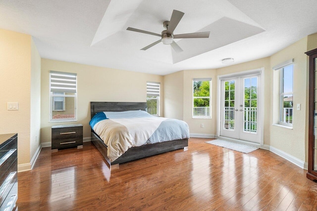 bedroom with access to exterior, french doors, baseboards, and hardwood / wood-style floors