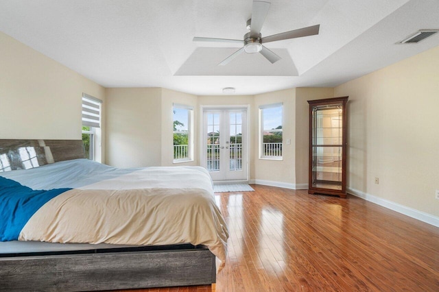 bedroom with french doors, multiple windows, light wood-style flooring, and visible vents