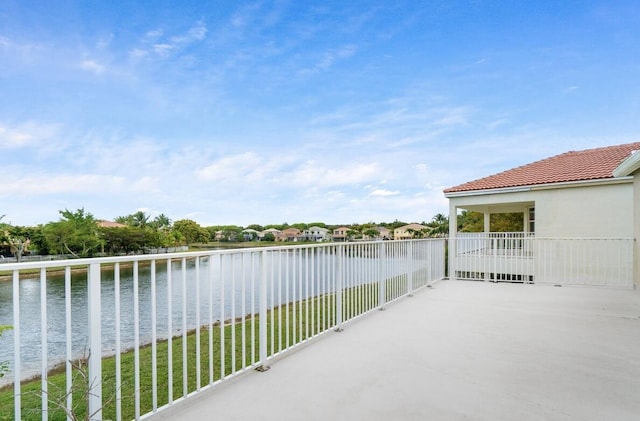 balcony with a water view and a patio