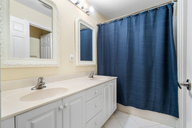 bathroom featuring tile patterned flooring, a sink, a shower with shower curtain, and double vanity