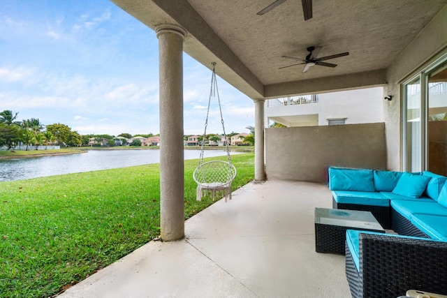 view of patio / terrace featuring a water view, ceiling fan, and an outdoor hangout area