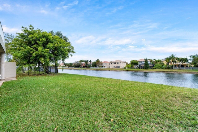 water view featuring a residential view and fence