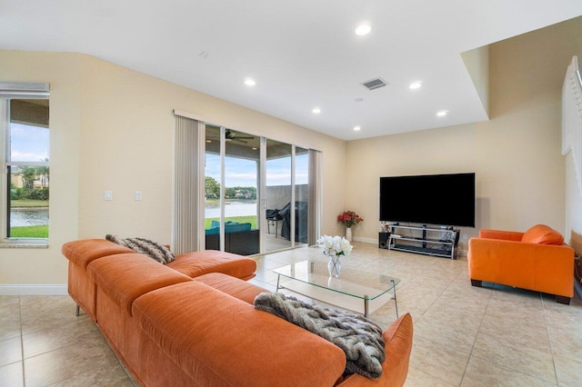 living room featuring baseboards, light tile patterned floors, visible vents, and recessed lighting