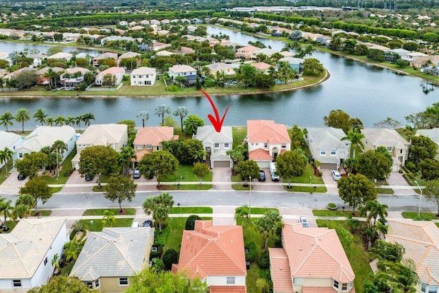 drone / aerial view with a residential view and a water view