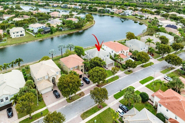 drone / aerial view featuring a water view and a residential view