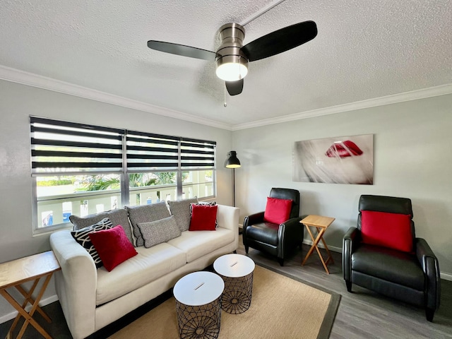 living room featuring a healthy amount of sunlight, crown molding, and wood finished floors