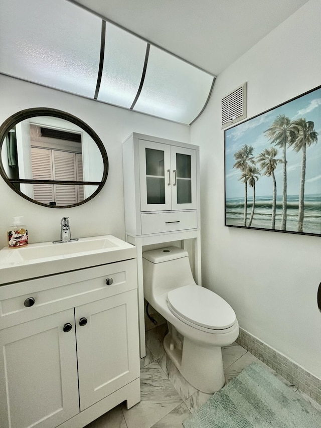 bathroom featuring baseboards, visible vents, toilet, marble finish floor, and vanity