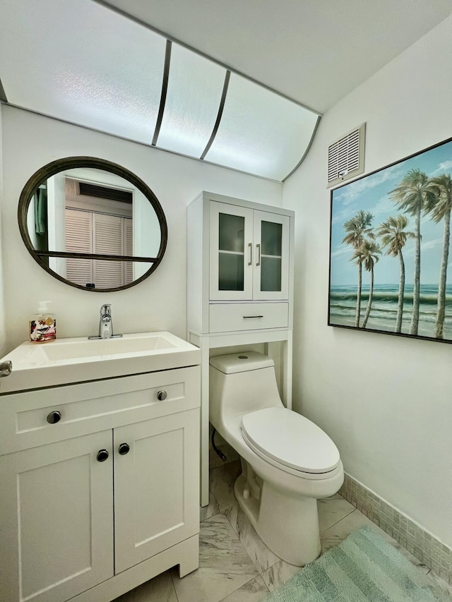 bathroom featuring baseboards, visible vents, toilet, marble finish floor, and vanity