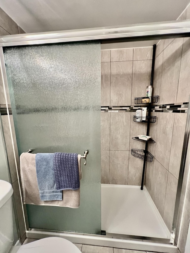 full bath with a shower stall and toilet