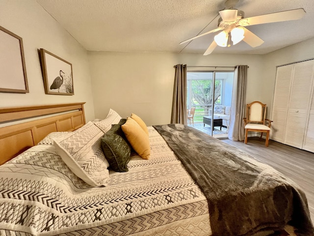 bedroom featuring a textured ceiling, wood finished floors, a ceiling fan, and access to exterior