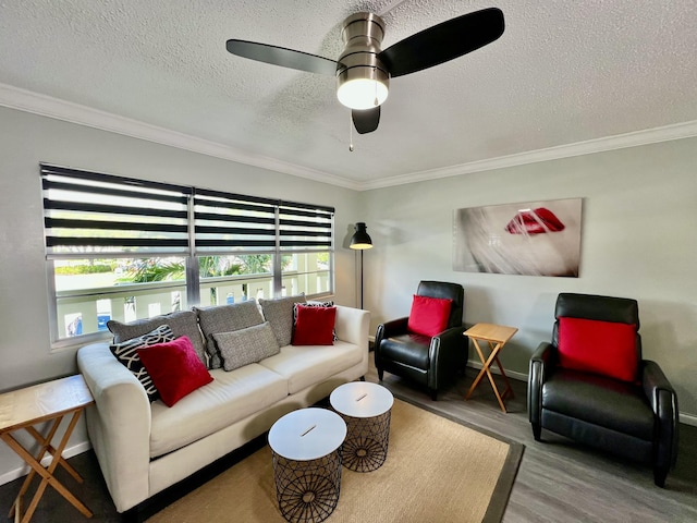 living area with a textured ceiling, ornamental molding, wood finished floors, and a wealth of natural light