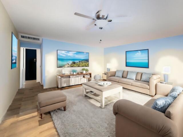 living room with light wood-style flooring, visible vents, and a ceiling fan