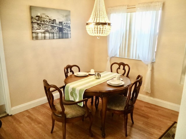 465 Saxony J, Delray Beach, FL 33446 - dining area featuring an inviting chandelier, baseboards, and wood finished floors