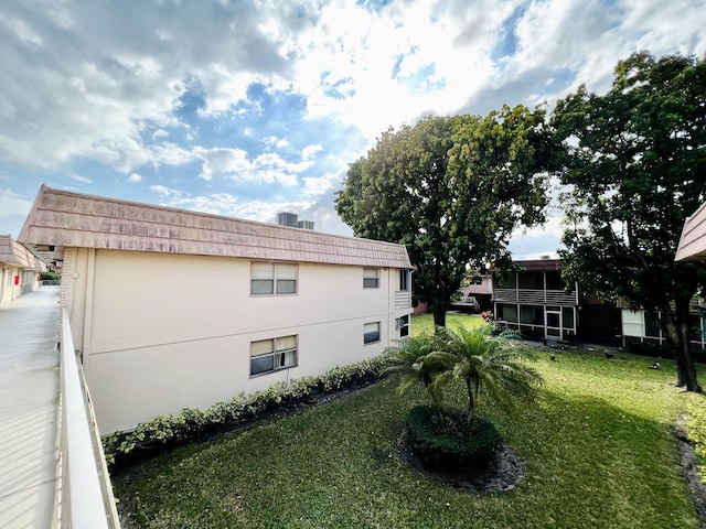 465 Saxony J, Delray Beach, FL 33446 - view of home's exterior featuring a lawn and stucco siding