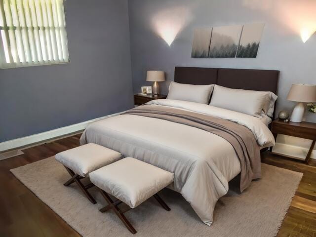 465 Saxony J, Delray Beach, FL 33446 - bedroom featuring dark wood-style flooring, visible vents, and baseboards