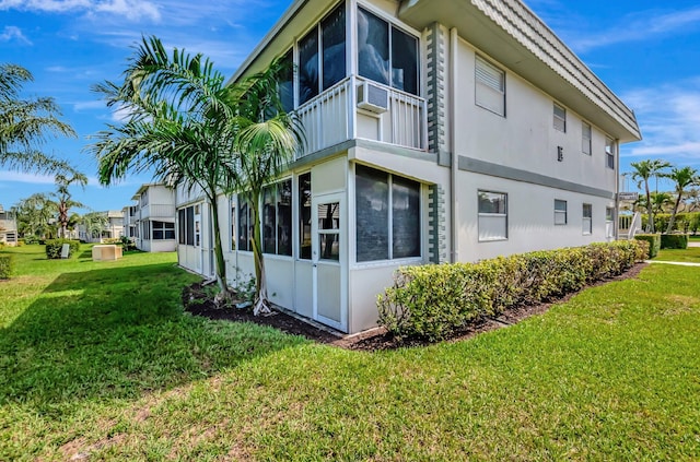 view of property exterior featuring cooling unit, a lawn, and stucco siding