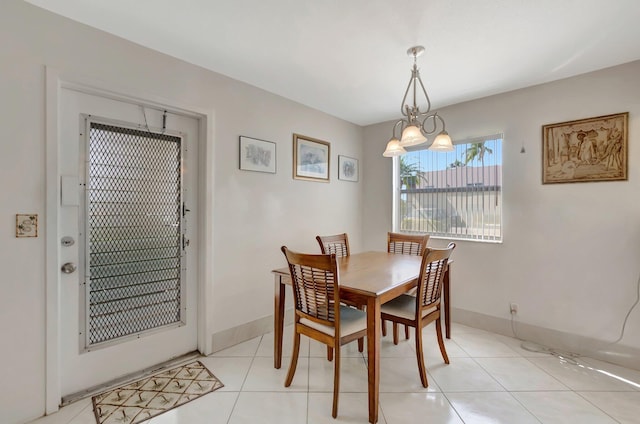 dining space featuring light tile patterned flooring and baseboards