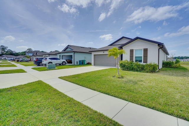 single story home featuring an attached garage, concrete driveway, a front yard, and stucco siding