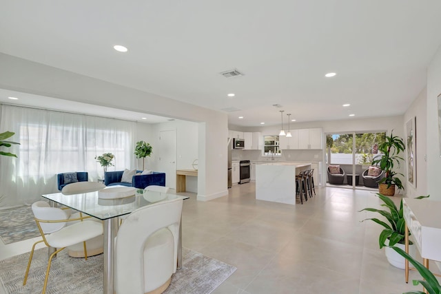 dining area featuring recessed lighting, visible vents, and light tile patterned floors