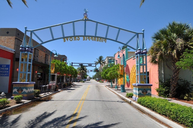 view of road featuring sidewalks, street lighting, and curbs