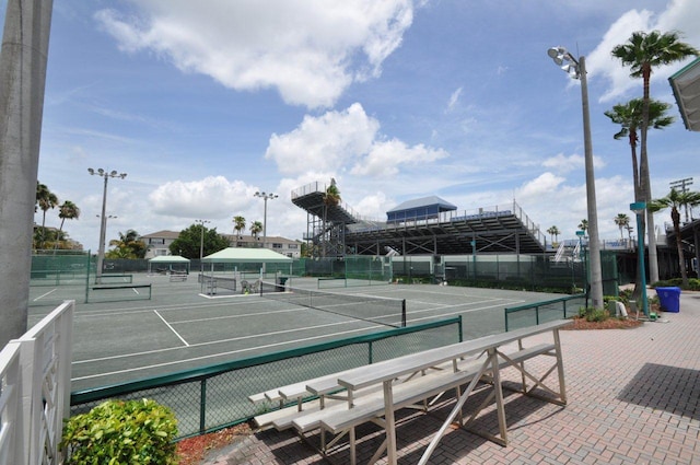 view of tennis court featuring fence