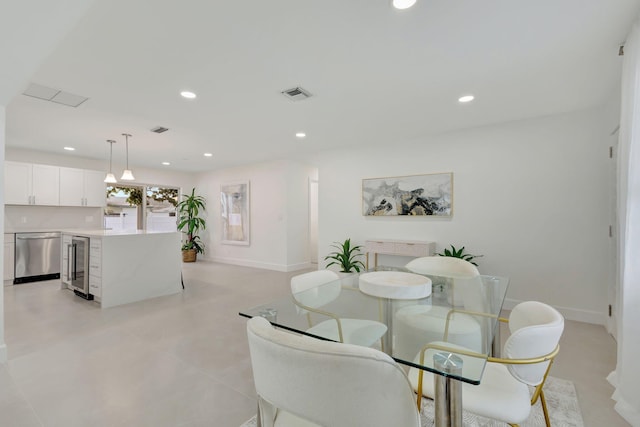 dining room featuring baseboards, wine cooler, visible vents, and recessed lighting