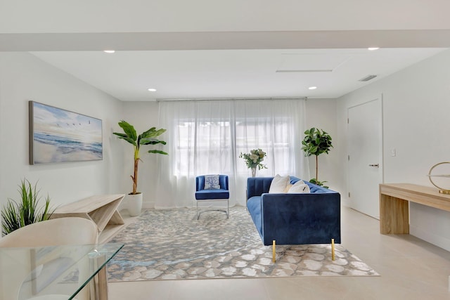 living area with attic access, visible vents, and recessed lighting