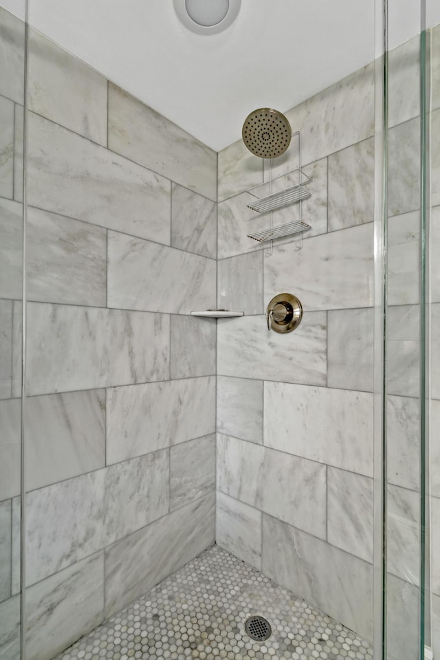 bathroom with a tile shower