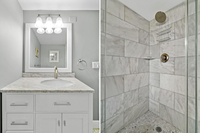 bathroom with tiled shower and vanity