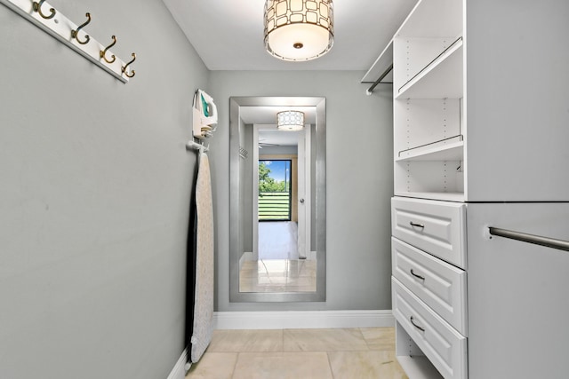 walk in closet with light tile patterned floors