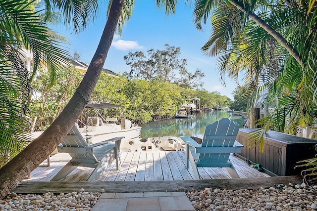 wooden terrace featuring a dock and a water view