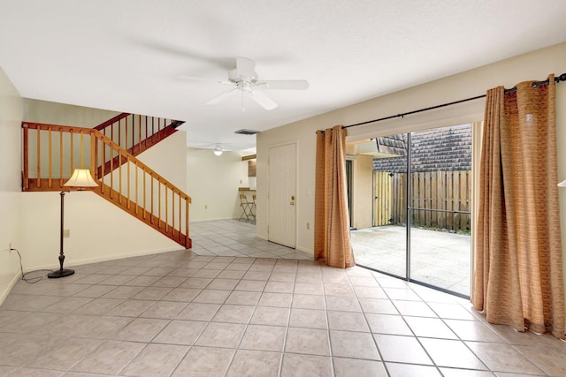 empty room with a ceiling fan, visible vents, stairway, and light tile patterned floors