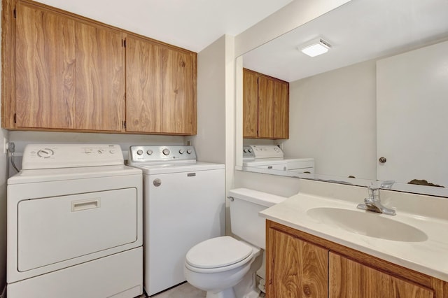 bathroom featuring separate washer and dryer, vanity, and toilet