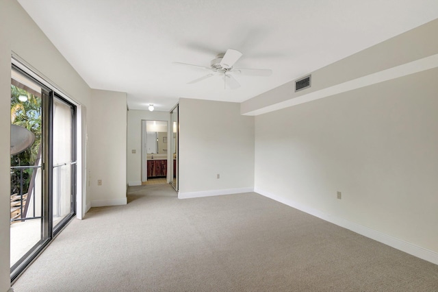 empty room featuring baseboards, visible vents, ceiling fan, and light colored carpet