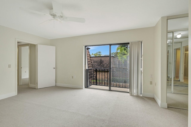 unfurnished bedroom with a ceiling fan, access to outside, light colored carpet, and baseboards