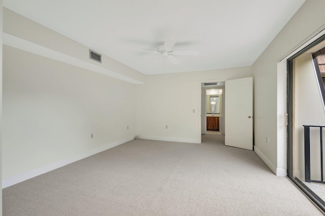 empty room with light carpet, baseboards, visible vents, and a ceiling fan