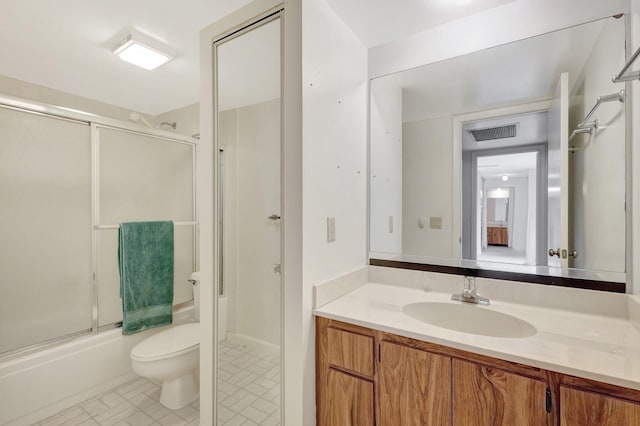 full bathroom with visible vents, shower / bath combination with glass door, vanity, and toilet