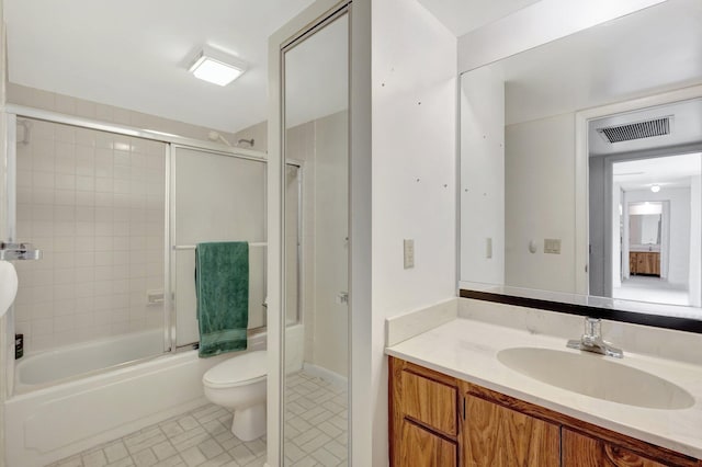 bathroom featuring toilet, vanity, visible vents, and enclosed tub / shower combo