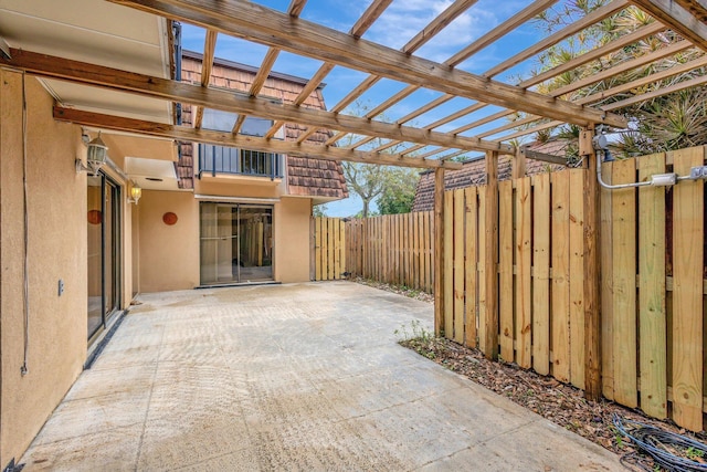 view of patio / terrace featuring fence and a pergola