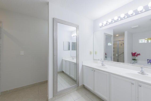 bathroom with double vanity, a sink, and tile patterned floors