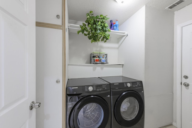 laundry area featuring laundry area, independent washer and dryer, and visible vents