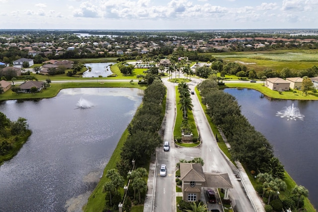 drone / aerial view with a water view and a residential view