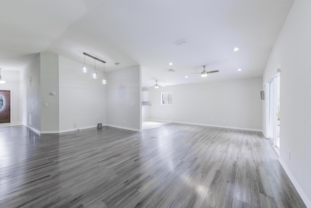 unfurnished living room with dark wood-type flooring, recessed lighting, visible vents, and baseboards