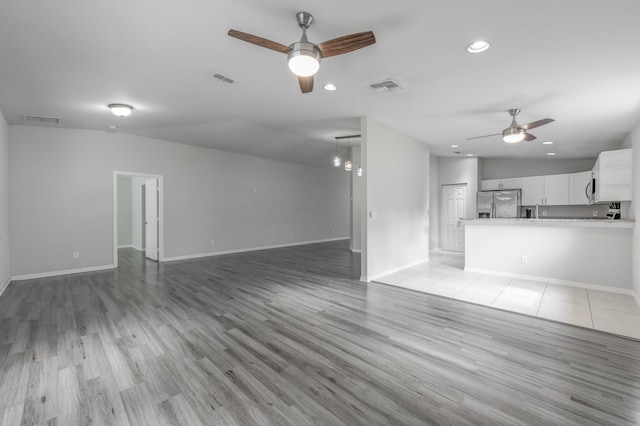 unfurnished living room featuring visible vents, a ceiling fan, and recessed lighting