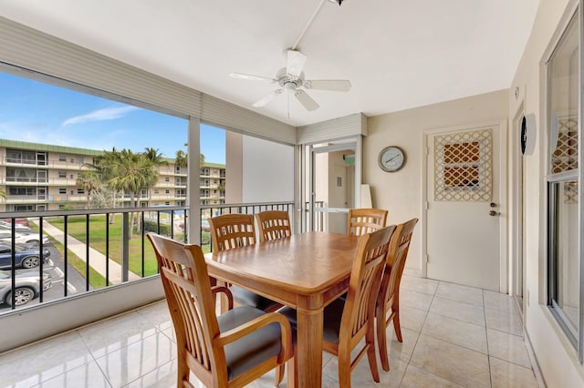 dining area with a ceiling fan, light tile patterned flooring, and plenty of natural light