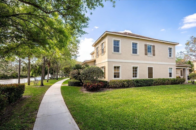 view of property exterior with a lawn and stucco siding