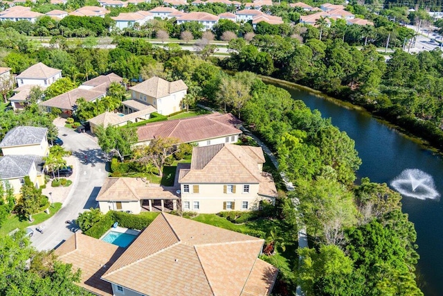 birds eye view of property with a water view and a residential view