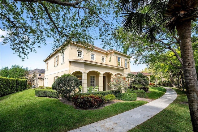 view of front of house with a front lawn and stucco siding