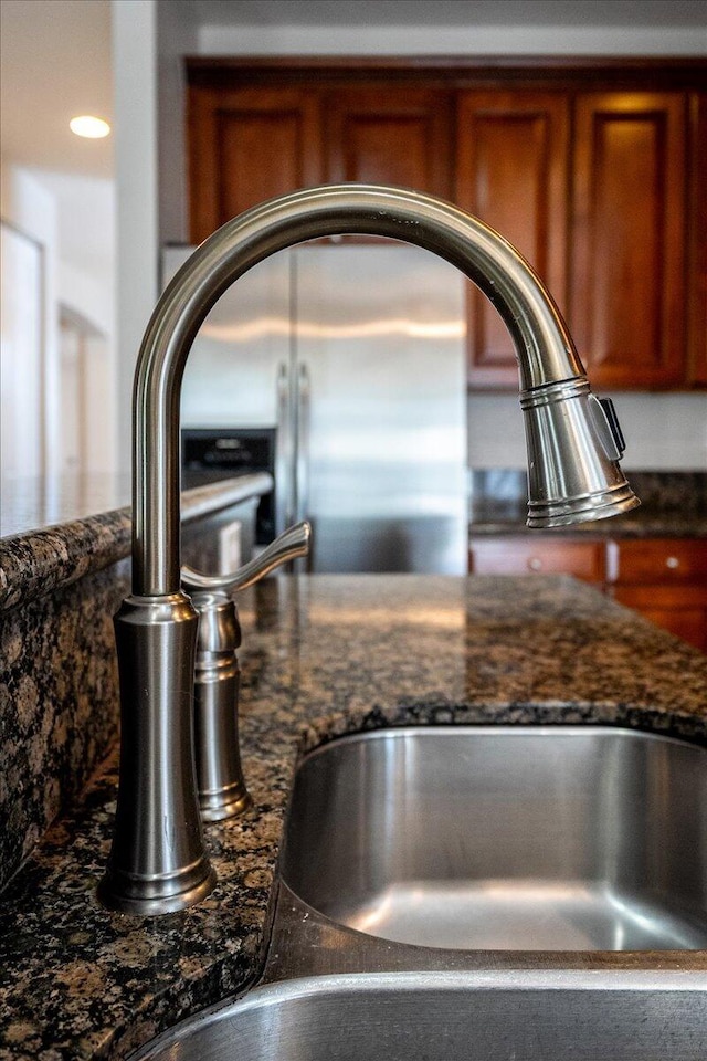 details featuring dark stone counters and a sink