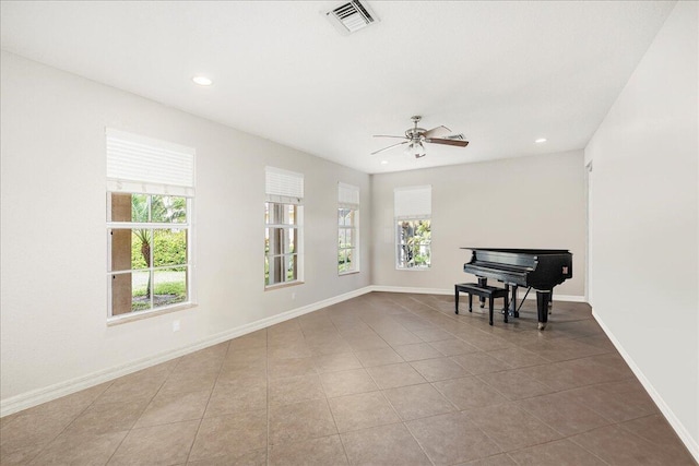 living area with recessed lighting, a healthy amount of sunlight, visible vents, and baseboards